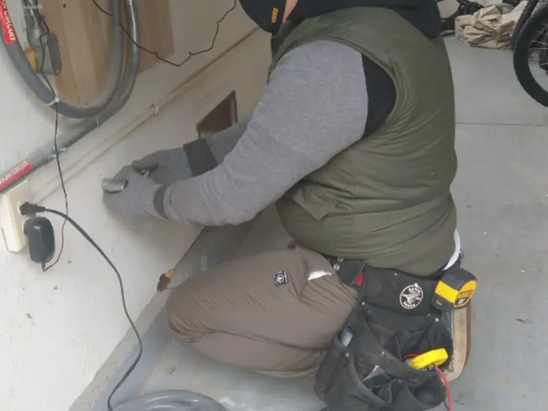 Electrician performing outlet wiring in a Bellingham garage